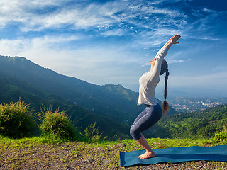 Image showing Woman doing yoga asana Utkatasana outdoors
