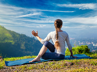 Image showing Woman practices yoga asana Marichyasana 