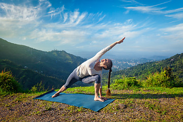 Image showing Woman practices yoga asana outdoors