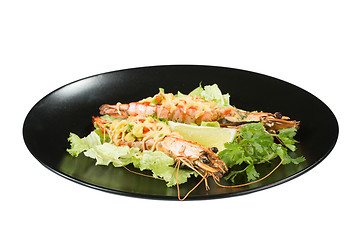 Image showing perfect dish with shrimps on a black plate. seafood