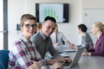 Image showing young business couple working on laptop, businesspeople group on