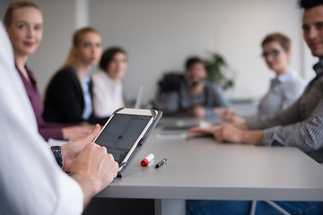 Image showing close up of  businessman hands  using tablet on meeting