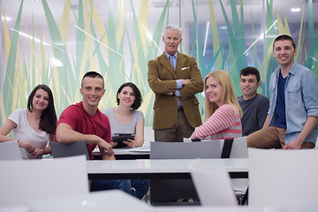 Image showing portrait of  teacher with students group in background