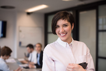 Image showing hispanic businesswoman with tablet at meeting room