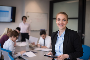 Image showing business woman working on tablet at meeting room