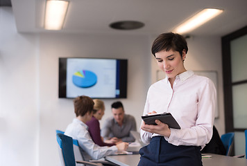 Image showing hispanic businesswoman with tablet at meeting room