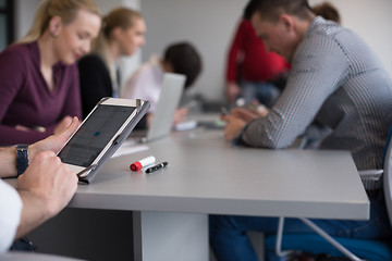 Image showing close up of  businessman hands  using tablet on meeting