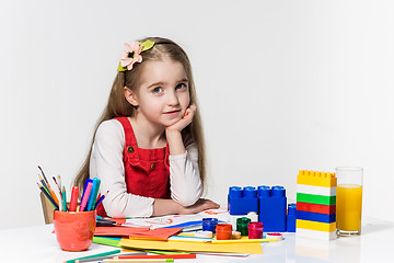 Image showing Cute little girl drawing with paint and paintbrush at home