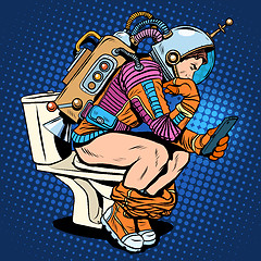 Image showing Astronaut thinker on the toilet reading a smartphone