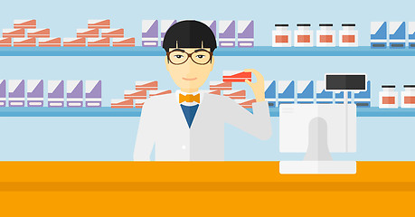 Image showing Pharmacist showing some medicine.