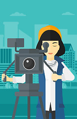 Image showing Camerawoman with movie camera on a tripod.