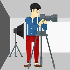 Image showing Photographer working with camera on a tripod.