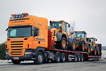 Image showing Yellow Scania Hauls Long Load