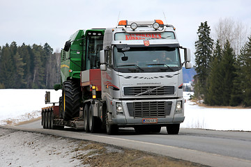 Image showing Volvo FH Hauls John Deere Combine