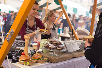 Image showing Women serving hamburgers on food festival in Ljubljana, Slovenia.