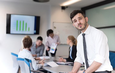 Image showing young business man with tablet at office meeting room