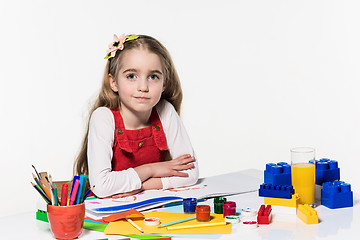 Image showing Cute little girl drawing with paint and paintbrush at home