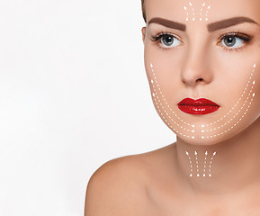 Image showing The beautiful woman face  with arrows close up over white background