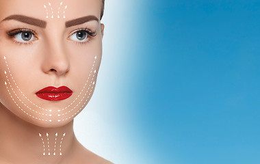 Image showing The beautiful woman face  with arrows close up over blue background