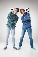 Image showing The two boys with balls on gray background