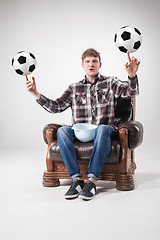 Image showing The portrait of fan with balls, holding dish on gray background