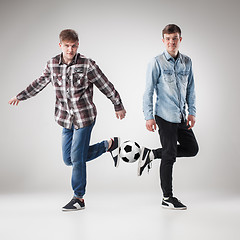 Image showing The two boys with balls on gray background