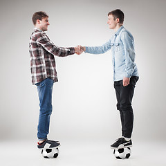 Image showing The two boys with balls on gray background