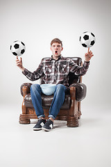 Image showing The portrait of fan with balls, holding dish on gray background