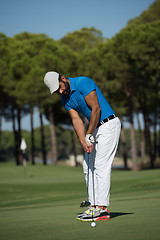 Image showing golf player hitting shot at sunny day