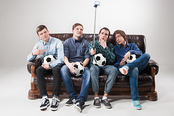 Image showing The four guys with balls on gray background