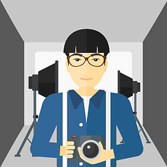 Image showing Smiling photographer holding camera.