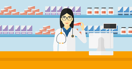 Image showing Pharmacist showing some medicine.