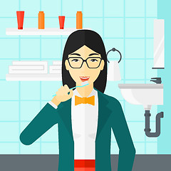 Image showing Woman brushing teeth.