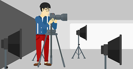 Image showing Photographer working with camera on a tripod.