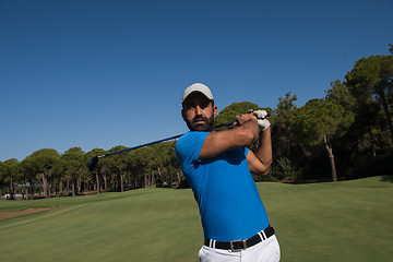 Image showing golf player hitting shot