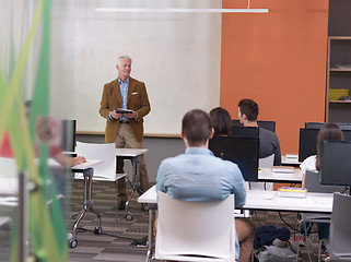 Image showing senior teacher and students group in computer lab classroom