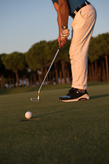 Image showing golfer  hitting shot at golf course