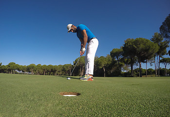 Image showing golf player hitting shot at sunny day