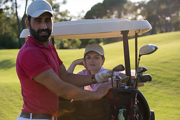 Image showing couple in buggy on golf course