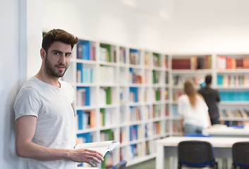 Image showing student in school library using tablet for research