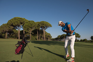 Image showing golf player hitting shot