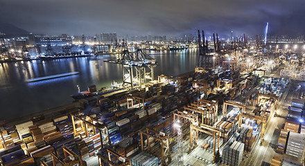 Image showing Cargo ship and crane at port reflect on sea bay,