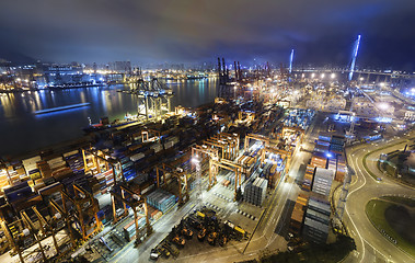 Image showing Cargo ship and crane at port reflect on sea bay,