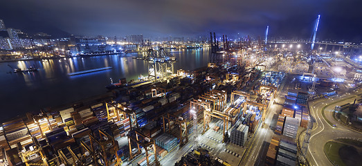 Image showing Cargo ship and crane at port reflect on sea bay,