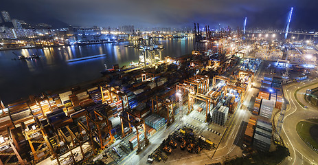 Image showing Cargo ship and crane at port reflect on sea bay,