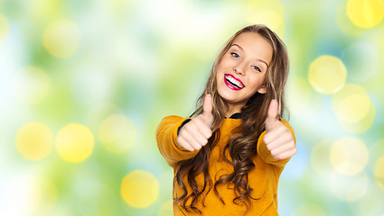 Image showing happy young woman or teen girl showing thumbs up