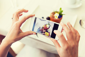 Image showing close up of woman picturing food by smartphone