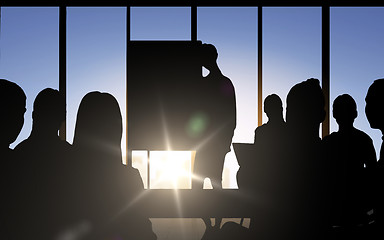 Image showing business people silhouettes at meeting in office