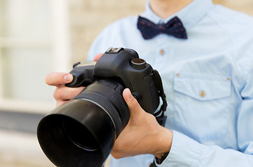 Image showing close up of male photographer with digital camera