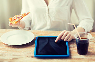 Image showing close up of woman with tablet pc having dinner